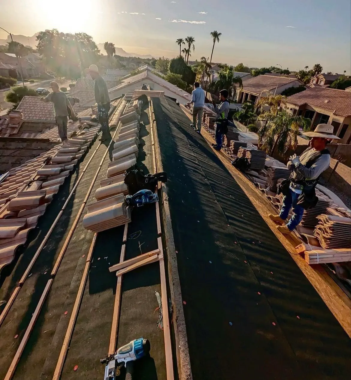 Eco Roofing Solutions crew stripping and re-laying concrete tile on a home at first light