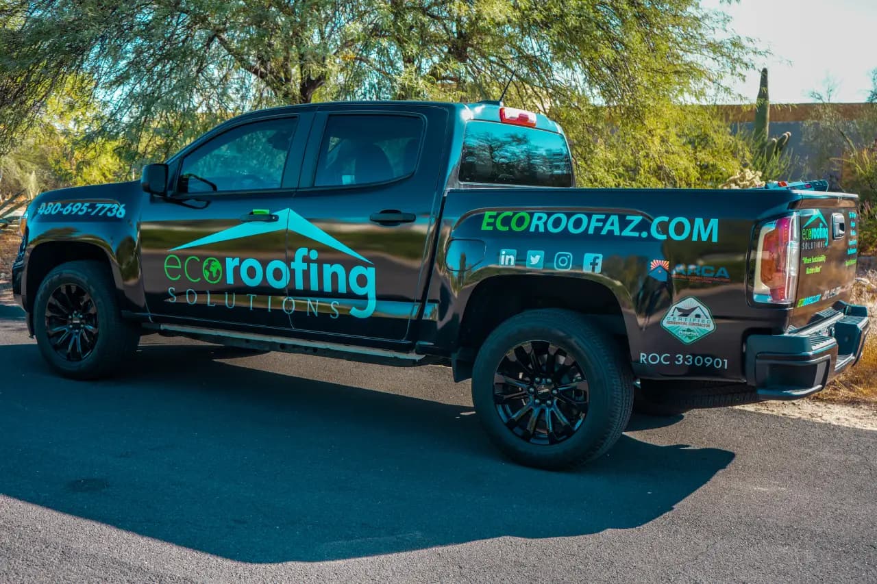 Eco Roofing Solutions branded pickup truck with the company phone number and ROC licence on the tailgate